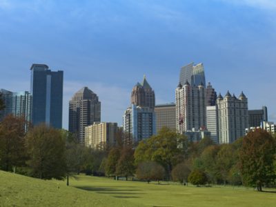 Row of trees in Piedmont park with view of Atlanta Ga skyline